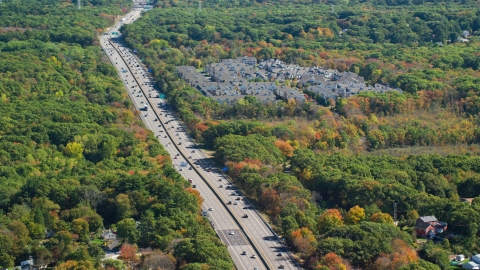 AX143_010.0000094 - Aerial stock photo of Pilgrims Highway and condominium complex in autumn, Braintree, Massachusetts