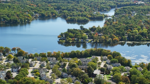 AX143_015.0000125 - Aerial stock photo of A small town on the shore of Whitmans Pond in autumn, Weymouth, Massachusetts