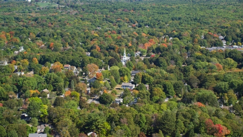 AX143_017.0000354 - Aerial stock photo of A small town with autumn trees around a church, Hingham, Massachusetts