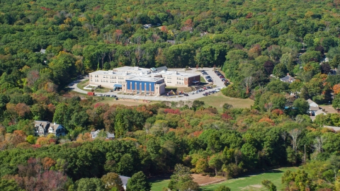 AX143_021.0000208 - Aerial stock photo of East Elementary in autumn, Hingham, Massachusetts