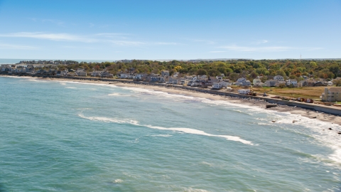 AX143_036.0000206 - Aerial stock photo of A beach and oceanfront homes, Scituate, Massachusetts