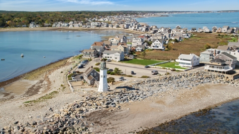 AX143_040.0000335 - Aerial stock photo of Old Scituate Light, beach, and oceanfront homes, Scituate, Massachusetts