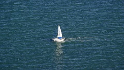 AX143_125.0000349 - Aerial stock photo of A small sailing boat on Cape Cod Bay, Massachusetts