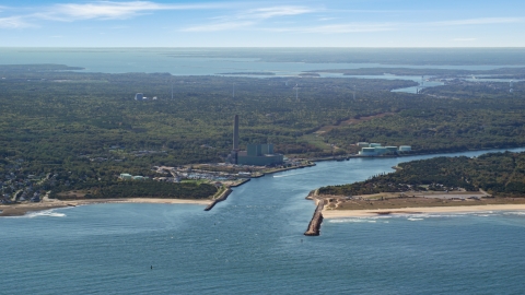 AX143_127.0000139 - Aerial stock photo of A power plant beside Cape Cod Canal, Sandwich, Cape Cod, Massachusetts