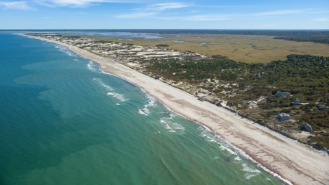 AX143_131.0000105 - Aerial stock photo of A stretch of beach with homes in Barnstable, Massachusetts