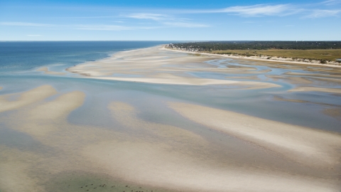 AX143_149.0000000 - Aerial stock photo of Sand bars by small coastal town, Cape Cod, Dennis, Massachusetts