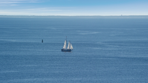 AX143_220.0000000 - Aerial stock photo of A sailing boat in Cape Cod Bay, Massachusetts