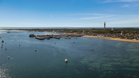 AX143_221.0000256 - Aerial stock photo of Piers by a small coastal town, Provincetown, Massachusetts