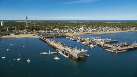 AX143_224.0000000 - Aerial stock photo of Piers and boats near a small coastal town, Provincetown, Massachusetts