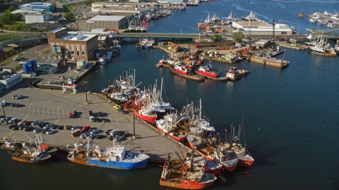 AX144_195.0000051 - Aerial stock photo of Numerous fishing boats at piers in New Bedford, Massachusetts