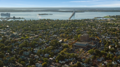 AX144_227.0000210 - Aerial stock photo of A coastal community near a bridge spanning the water, Newport, Rhode Island