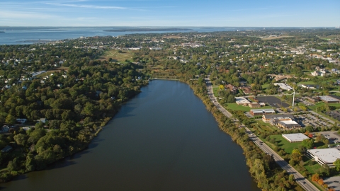 AX144_260.0000066 - Aerial stock photo of A coastal community and green trees, Newport, Rhode Island