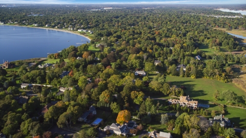 AX145_017.0000000 - Aerial stock photo of Homes and colorful trees near the shore, Barrington, Rhode Island