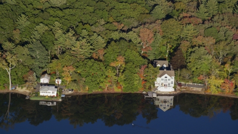 AX145_106.0000227 - Aerial stock photo of A pair of waterfront homes on Lake Mirimichi in autumn, Plainville, Massachusetts