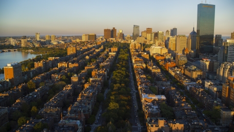 AX146_062.0000288F - Aerial stock photo of Back Bay brownstones and Downtown Boston skyscrapers, Massachusetts, sunset