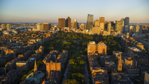 AX146_064.0000094F - Aerial stock photo of Historic Boston Common and skyscrapers in Downtown Boston, Massachusetts, sunset
