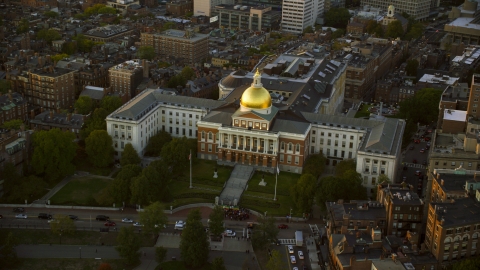 AX146_086.0000161F - Aerial stock photo of The Massachusetts State House in Downtown Boston, Massachusetts, sunset