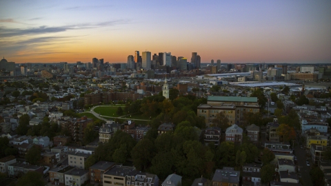 AX146_121.0000000F - Aerial stock photo of The Dorchester Heights Monument and the city skyline, South Boston, Massachusetts, twilight