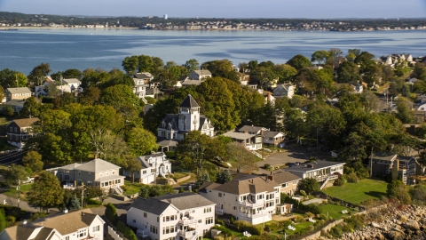 AX147_017.0000149 - Aerial stock photo of Houses in a coastal community on a peninsula, Nahant, Massachusetts