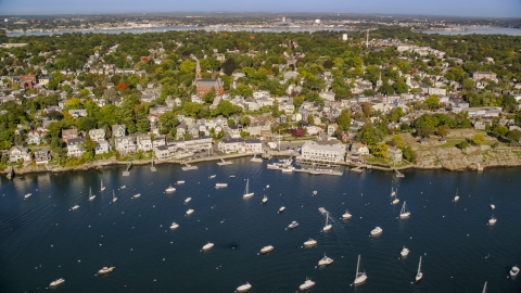 AX147_025.0000281 - Aerial stock photo of A coastal community by a harbor with boats, Marblehead, Massachusetts