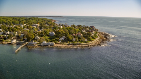 AX147_079.0000157 - Aerial stock photo of Oceanfront homes on a rocky coast in Gloucester, Massachusetts