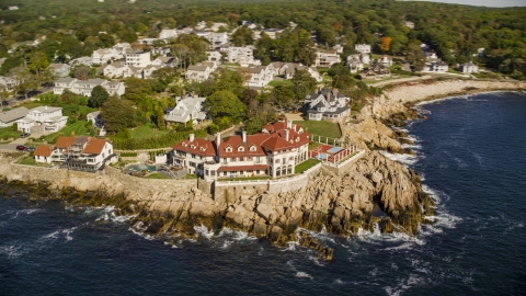 AX147_080.0000237 - Aerial stock photo of Oceanfront homes and a mansion in Gloucester, Massachusetts