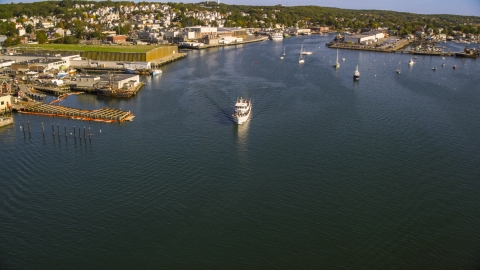 AX147_088.0000030 - Aerial stock photo of A ferry by a small coastal town, Gloucester, Massachusetts