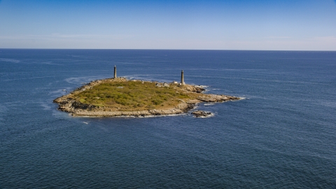 AX147_109.0000282 - Aerial stock photo of Thatcher Island with two lighthouses, Massachusetts