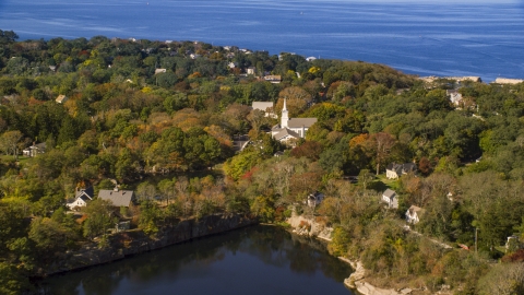 AX147_132.0000052 - Aerial stock photo of A church in a small coastal town in autumn, Gloucester, Massachusetts
