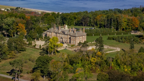 AX147_141.0000156 - Aerial stock photo of The Great House at Crane Estate and Castle Hill surrounding by trees in autumn, Ipswich, Massachusetts