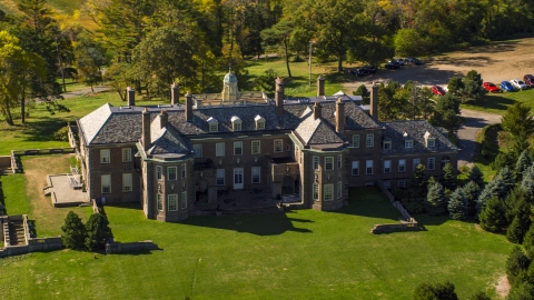 AX147_143.0000265 - Aerial stock photo of Close-up view of The Great House at Crane Estate in autumn, Ipswich, Massachusetts