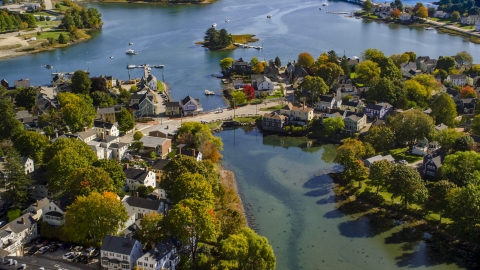 AX147_185.0000060 - Aerial stock photo of A small bridge and waterfront homes in autumn, Portsmouth, New Hampshire