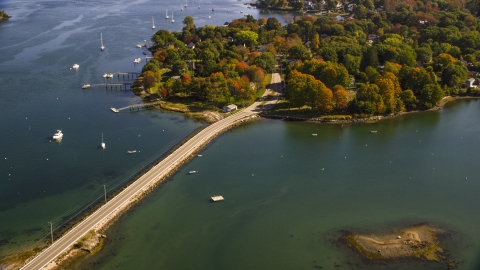 AX147_189.0000000 - Aerial stock photo of A small bridge leading to coastal homes in autumn, New Castle, New Hampshire
