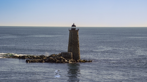 AX147_194.0000260 - Aerial stock photo of A view of a lighthouse overlooking the ocean, Kittery, Maine