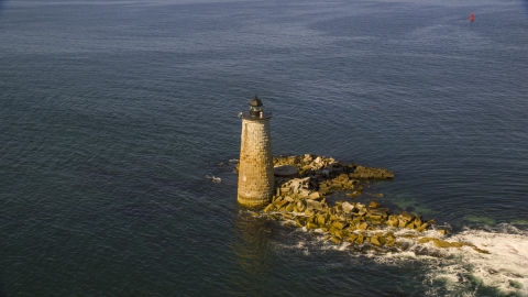 AX147_196.0000000 - Aerial stock photo of A lighthouse in the water by rocky shore, Kittery, Maine