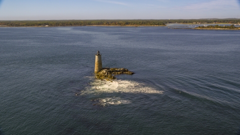 AX147_196.0000233 - Aerial stock photo of Lighthouse and rocks in the water, Kittery, Maine