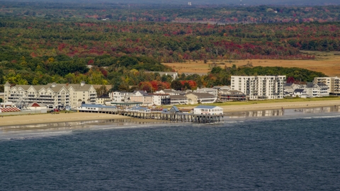 AX147_295.0000000 - Aerial stock photo of A beach and pier by colorful autumn trees, Old Orchard Beach, Maine