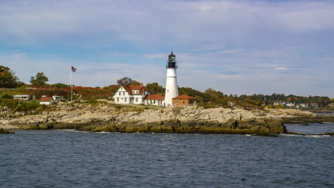 AX147_312.0000000 - Aerial stock photo of The Portland Head Light seen from the water, autumn, Cape Elizabeth, Maine