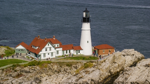 AX147_315.0000249 - Aerial stock photo of The Portland Head Light on a rocky shore overlooking the ocean in autumn, Cape Elizabeth, Maine