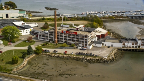 AX147_360.0000196 - Aerial stock photo of A small factory in autumn, Portland, Maine