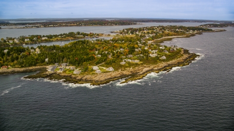 AX147_379.0000071 - Aerial stock photo of A coastal town on Bailey Island with autumn trees, Harpswell, Maine