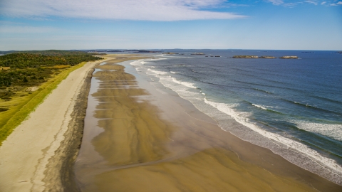 AX147_385.0000067 - Aerial stock photo of Waves rolling onto the beach in autumn, Phippsburg, Maine