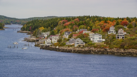 AX147_397.0000202 - Aerial stock photo of Waterfront homes, colorful trees in autumn, Georgetown, Maine