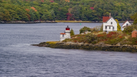 AX147_402.0000184 - Aerial stock photo of Squirrel Point Light beside the water in Arrowsic, Maine