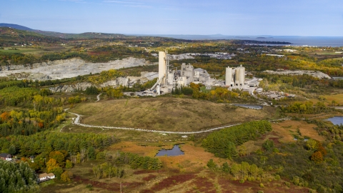 AX148_073.0000000 - Aerial stock photo of A quarry and factory in autumn, Thomaston, Maine