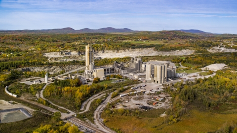 AX148_074.0000000 - Aerial stock photo of A factory near a quarry in autumn, Thomaston, Maine