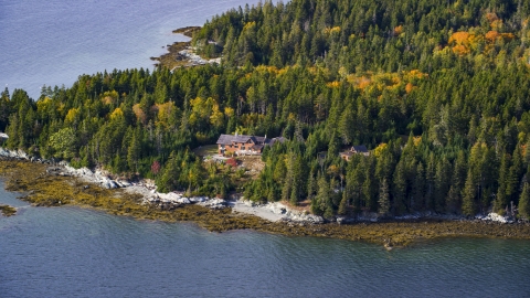 AX148_136.0000238 - Aerial stock photo of A waterfront home on an island in autumn, Little Deer Isle, Maine