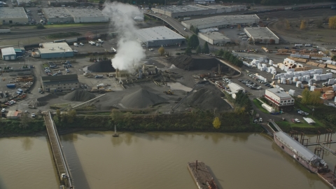 AX153_062.0000190F - Aerial stock photo of A manufacturing plant and rising steam, Northwest Portland, Oregon