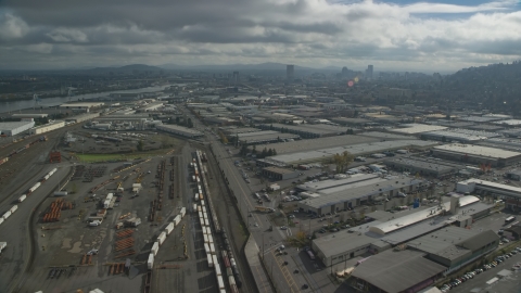 AX153_064.0000359F - Aerial stock photo of A train yard and warehouses in Northwest Portland, Oregon