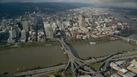 AX153_092.0000000F - Aerial stock photo of Downtown skyscrapers and the Morrison Bridge in Downtown Portland, Oregon